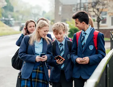 Children in school uniform walking and checking their results