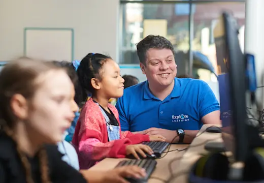 A young girl in an Explore Learning centre with a tutor doing 11 plus and entrance exam tuition