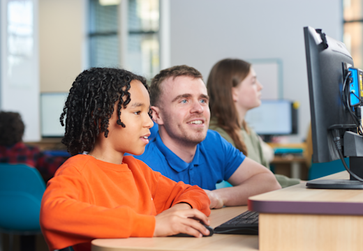 Tutor supporting a child with SATs preparation in an Explore Learning centre