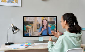 Young girl taking part in an online tuition session and getting individual attention from her tutor.
