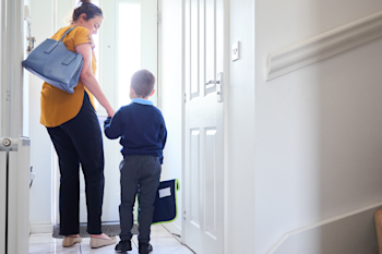 Mother and son leaving the house for school