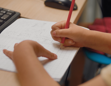 A child writing in a workbook